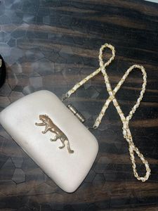 Sabyasachi white shoulder clutch with logo design