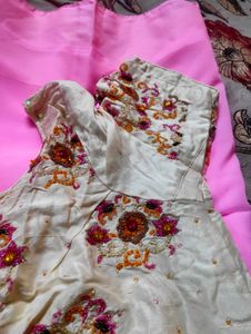 Embroidered silk blouse and plain pink saree