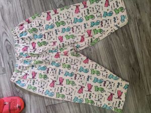 Bundle of baby clothes, beanie, shoes.
