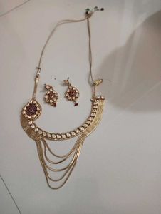 golden and red necklace with earring