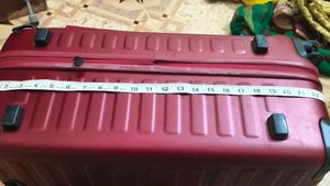 Maroon Hard Shell Luggage Handel grip is broken