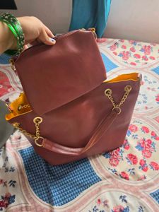 Chic Maroon Handbag with Gold Chain Accents