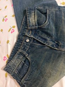 Faded indigo blue denim jeans