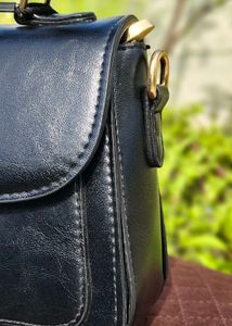 Chic Black Handbag with Gold Embellishment