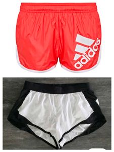 running Shorts - oranish Red & Black/White