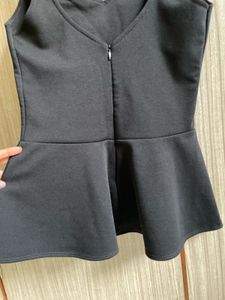 Chic Black Peplum Top with Heart Cutout