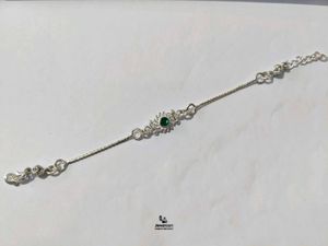 Elegant Pure Silver Rakhi with Green Stone