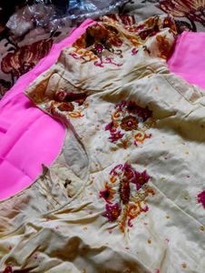 Embroidered silk blouse and plain pink saree
