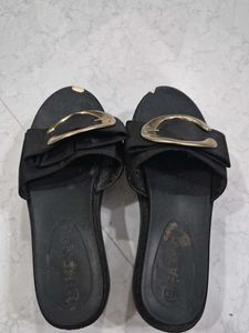Stylish Black Slip-On Sandals with Gold Accent