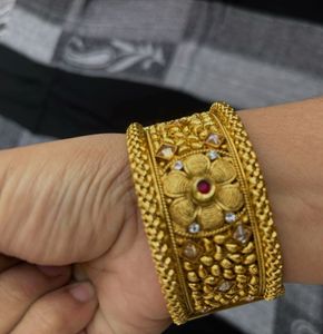 Traditional Gold Bangles with Intricate Floral De