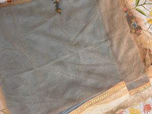Powder blue floral net saree