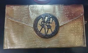 Beautiful golden Clutch with a bronze buckle