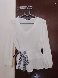 Chic White Peplum Top with Bow Accent