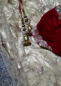 The maroon  lehenga   with golden colour net gown