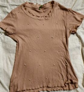 pink blouse with pearls attached