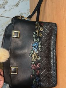 Chic Black Handbag with Pom-Pom Charm