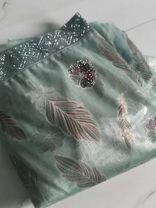 Elegant Teal Saree with Feather Motifs