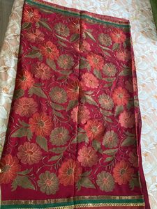 Maroon coloured Embroidered saree With Stitched blouse