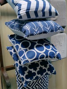 Five Cushions With Blue Cushion Cover