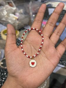 red and white seed beads bracelets with heart mess