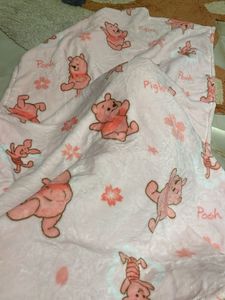 Winnie the Pooh plushie with blanket