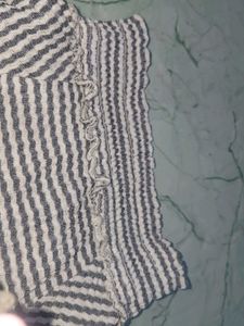 stripped knitted top with pom-poms on sleeve