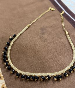 Elegant Gold Necklace with Black Beads