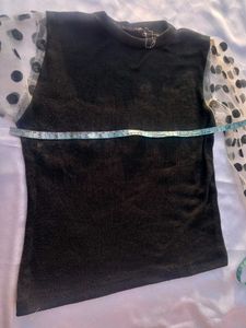 Chic Black Top with Polka Dot Sleeves