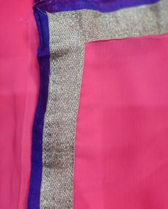 Pink colour saree with golden and purple border.