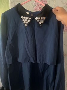 Elegant navy blouse with floral-embellished collar