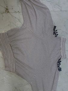 stripped knitted top with pom-poms on sleeve