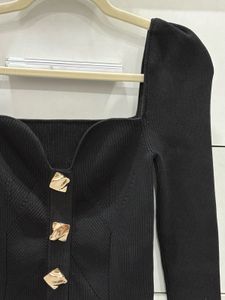 Chic Black Top with gold buttons