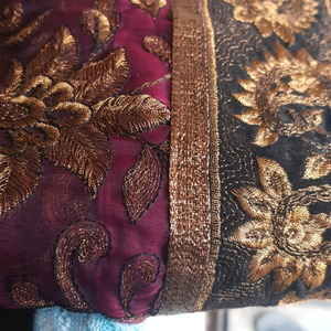 Silk type maroon saree with golden embroidery and