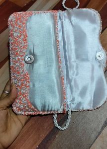 beautiful stylish orange and white colour sling ba
