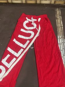 Red Wide-Leg Pants with Bold White Text