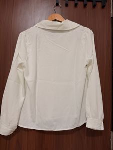 Elegant White Collared Blouse with Pearl Necklace