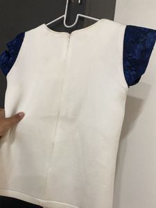 Elegant White Top with Blue Lace Sleeves