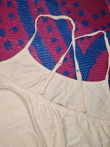 Cream-colored (or off-white) mini dress