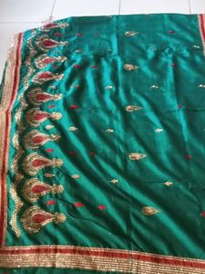 Elegant Teal Saree with Red & Gold Embellishments