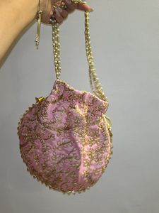 handmade Pink potli with gold embroidery
