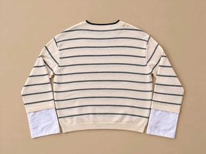 CREAM KNIT STRIPED SWEATER.