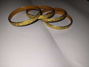 Set of 4 ornate gold bangles