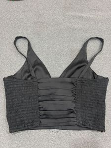 black ruched off-shoulder top or bandeau-style cro
