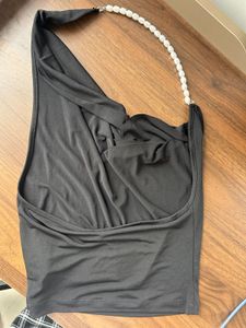 Black backless halter neck top with pearls
