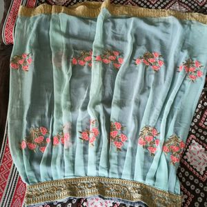 light blue colour fully stitched skirt with golden border in bottom and and work in flair .