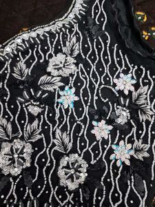 Selling a black color partywear stitched saree