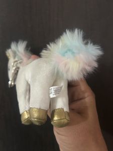 This white unicorn plush keychain features a shim