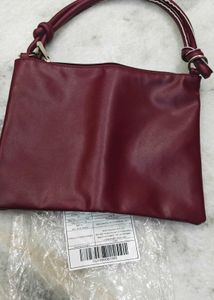 Clinique burgundy Leather Bag.