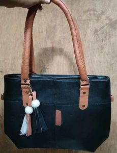Chic Black Tote Bag with Tassel Accent