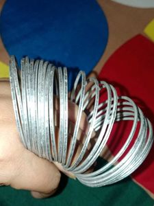 A dozen of silver metal bangles